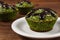 Fresh muffins with spinach, desiccated coconut and chocolate glaze, delicious healthy dessert