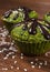 Fresh muffins with spinach, desiccated coconut and chocolate glaze, delicious healthy dessert