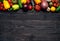 Fresh multi-colored vegetables rich in vitamins on a dark wooden background are located along the edge. Healthy fiber diet top