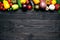 Fresh multi-colored vegetables rich in vitamins on a dark wooden background are located on the top edge with a place for text in t