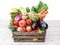 Fresh multi-colored vegetables in wooden crate.