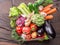 Fresh multi-colored vegetables in wooden crate. Top view.