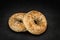 Fresh multi-grain bagel bread, isolated on a natural slate stone