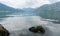 Fresh mussels in stone still alive with tide in a lake with mountains in kotor bay, Montenegro. Scenery landscape with crustacean