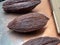 Fresh, natural, cocoa and cacao bean hulls sitting on a metal ta