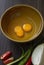 Fresh natural eggs in a bowl with spring onions and coriander to prepare for fried eggs, omelettes