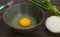 Fresh natural eggs in a bowl with spring onions and coriander to prepare for fried eggs, omelettes