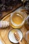 fresh natural linden honey in glass jar with wooden honey spoons around herb flowers. flat lay.