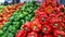 Fresh and natural red and green peppers piled in fruit market