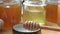 fresh natural various honey glass jars with wooden honey spoon.