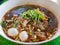 Fresh noodles soup with pork and its tasty thick broth Guay Tiao Nam Tok Moo - delicious and healthy street food in Thailand