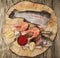 Fresh Norwegian rainbow trout with lemon red caviar, and onions on a wooden background