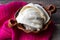 Fresh Oaxaca cheese in clay pot on wood background