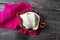 Fresh Oaxaca cheese in clay pot on wood background