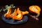 Fresh opened pumpkin on a dark table