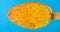 Fresh orange flavor popsicle melting timelapse on a blue background please rotate it at 90 degrees to get a vertical composition