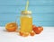 Fresh orange fresh clear kitchen glass with straw morning white and blue wooden, mandarins