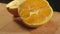 Fresh orange fruit half. Tasty orange slise on wooden background