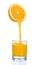 Fresh orange juice flowing from cut orange into the glass.