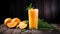 Fresh orange juice with ice and rosemary on a wooden background