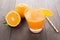 Fresh orange juice and oranges on wooden table