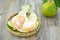 Fresh orange peeled in bamboo basket on wooden background