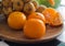 Fresh orange tangerines and fruit on wood plate