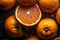 Fresh oranges on a dark background, some whole and some cut in half, covered in water droplets.