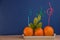 Fresh oranges with fancy colorful straws