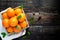 Fresh oranges fruit in wooden basket. Pile of oranges top view
