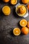 Fresh oranges juicer juice and tropical fruits on concrete board