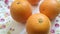 fresh oranges in orange color against a background of floral plates