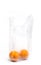 Fresh oranges in a transparent plastic bag after shopping in a store on a white background