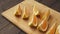 Fresh oranges on a wooden table, whole and sliced. A plate full of citrus slices.