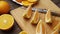 Fresh oranges on a wooden table, whole and sliced. A plate full of citrus slices.