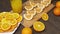 Fresh oranges on a wooden table, whole and sliced. A plate full of citrus slices.
