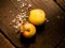 Fresh organic apples on a textured wooden table with sunlight. Warm light and wooden textures.