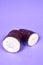 Fresh Organic Cassava Root, Manioc Esculenta, yuca On purple Background