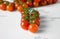 Fresh organic cherry tomatoes on white table