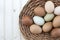 Fresh organic chickeneggs in old dusty basket on wooden backgrou
