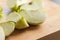 Fresh Organic Cut Green Apple CloseUp on Wooden Board - Crisp and Wholesome Slice