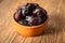 Fresh organic dates fruits in a clay bowl