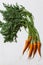 Fresh organic farmer carrots on white background, close-up, top view