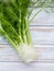 Fresh organic fennel bulbs for culinary purposes on wooden background.