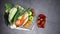 Fresh and organic fruits and vegetables appear in shopping bag and dark background - Stop motion