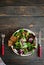 Fresh organic green quinoa salad bowl on dark wooden background