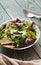 Fresh organic green quinoa salad bowl on dark wooden background