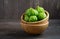 Fresh organic green tomatillos Physalis philadelphica with a husk on rustic wooden table.