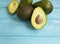 Fresh organic healthy avocado heap on blue wooden natural