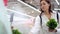 fresh organic herbs in supermarket, woman is taking salad greens from shelves